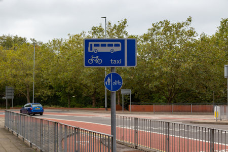 A road sign along side a bus and cycle laneの写真素材
