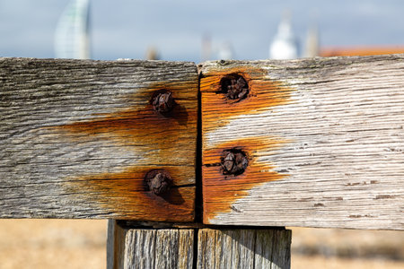 Rusty screws inside wooden planksの写真素材