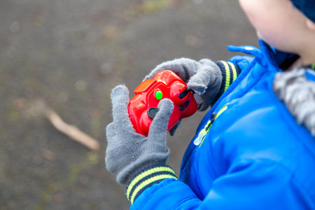 A child holding the control of a remote control car outsideの写真素材