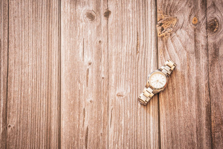A mens silver wrist watch on a rustic wooden background with copy spaceの写真素材