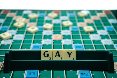 The Word gay spelled with scrabble tiles on a scrabble boardのeditorial素材