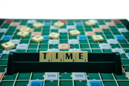 The Word time spelled with scrabble tiles on a scrabble boardのeditorial素材