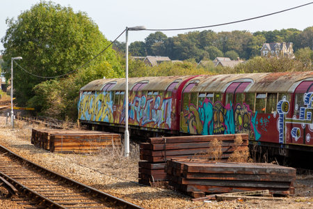 09/15/2020 Ryde, Isle of Wight, UK An old underground or tube train covered in graffiti on the side of a train trackのeditorial素材