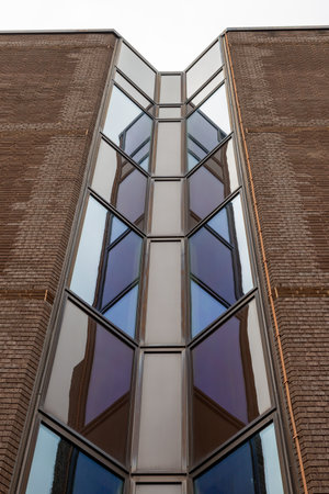 symmetrical glass reflections of a modern office blockのeditorial素材