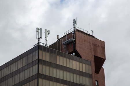An office building with Mobile phone antennas and masts on the roofのeditorial素材
