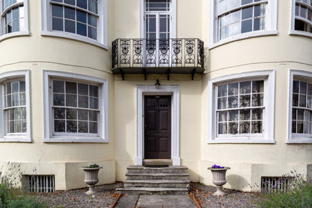 the entrance to a large Victorian house with bay windows either side of the front doorのeditorial素材