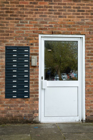 The entrance to a block of flats or apartments with a letter box for each flat on the outsideのeditorial素材