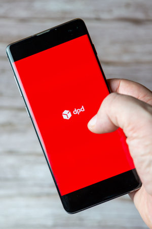 01-30-2021 Portsmouth, Hampshire, UK A hand holding a mobile phone or cell phone with the dpd delivery app open on screenのeditorial素材