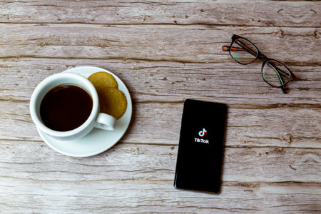 01-30-2021 Portsmouth, Hampshire, UK A mobile phone or cell phone laid on a table with the TikTok app openのeditorial素材