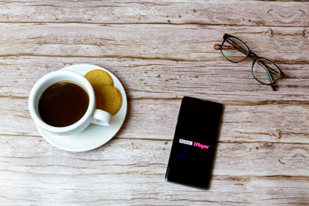 01-30-2021 Portsmouth, Hampshire, UK A mobile phone or cell phone laid on a table with the BBC Iplayer app openのeditorial素材
