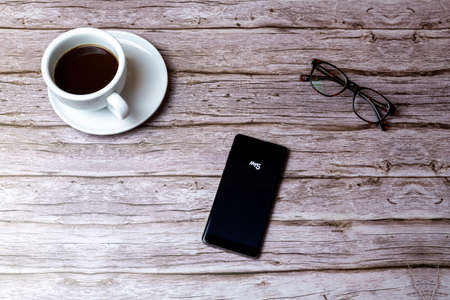 02-05-2021 Portsmouth, Hampshire, UK A mobile phone or cell phone laid on a wooden table or desk with the My5 TV app openのeditorial素材