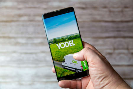02-05-2021 Portsmouth, Hampshire, UK A Mobile phone or cell phone being held showing the Yodel delivery app open on screenのeditorial素材