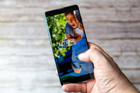 02-05-2021 Portsmouth, Hampshire, UK A Mobile phone or cell phone being held showing the Tesco clubcard app open on screenのeditorial素材