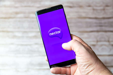 02-05-2021 Portsmouth, Hampshire, UK A Mobile phone or cell phone being held showing the Nectar app open on screenのeditorial素材