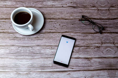 02-05-2021 Portsmouth, Hampshire, UK A mobile phone or cell phone laid on a wooden table or desk with the venmo app openのeditorial素材