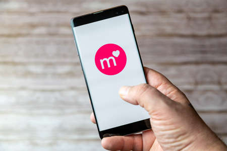 02-05-2021 Portsmouth, Hampshire, UK A Mobile phone or cell phone being held showing the Match dating app open on screenのeditorial素材