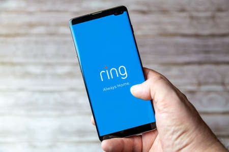 02-05-2021 Portsmouth, Hampshire, UK A Mobile phone or cell phone being held showing the Ring doorbell app open on screenのeditorial素材