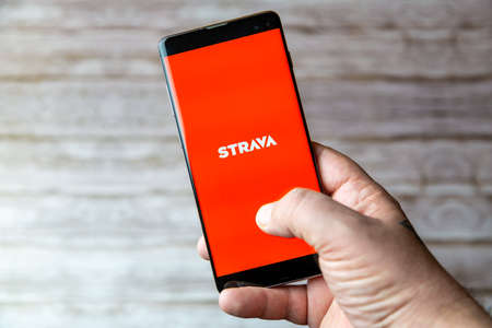 02-05-2021 Portsmouth, Hampshire, UK A Mobile phone or cell phone being held showing the Strava app open on screenのeditorial素材