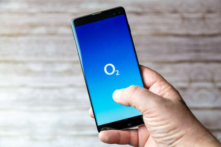 02-05-2021 Portsmouth, Hampshire, UK A Mobile phone or cell phone being held showing the O2 Mobile app open on screenのeditorial素材