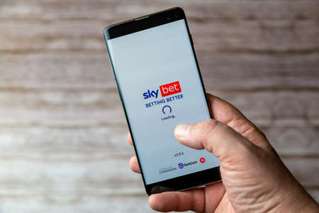 02-05-2021 Portsmouth, Hampshire, UK A Mobile phone or cell phone being held showing the Sky bet app open on screenのeditorial素材