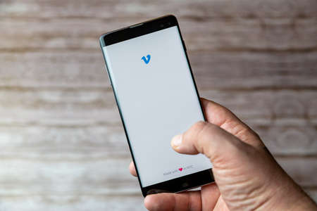 02-05-2021 Portsmouth, Hampshire, UK A Mobile phone or cell phone being held showing the Venmo app open on screenのeditorial素材