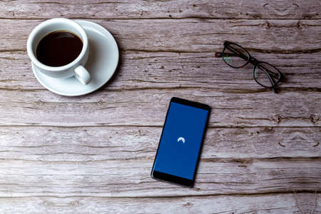 02-05-2021 Portsmouth, Hampshire, UK A mobile phone or cell phone laid on a wooden table or desk with the Nord VPN app openのeditorial素材