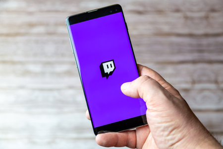 02-05-2021 Portsmouth, Hampshire, UK A Mobile phone or cell phone being held showing the Twitch streaming app open on screenのeditorial素材