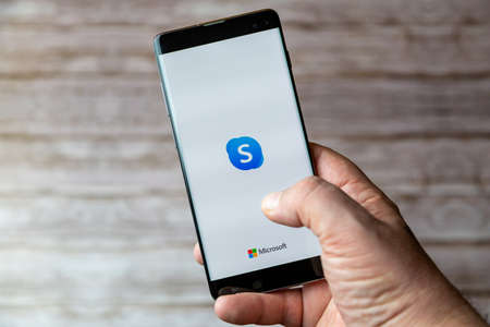 02-05-2021 Portsmouth, Hampshire, UK A Mobile phone or cell phone being held showing the Skype app open on screenのeditorial素材