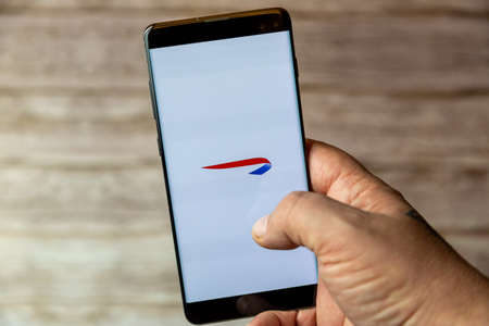 02-08-2021 Portsmouth, Hampshire, UK A mobile phone or cell phone being held in a hand with the British Airways app open on screenのeditorial素材