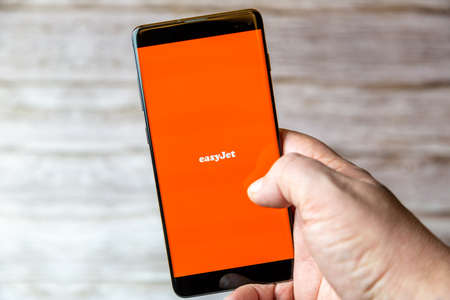 02-08-2021 Portsmouth, Hampshire, UK A mobile phone or cell phone being held in a hand with the Easyjet app open on screenのeditorial素材