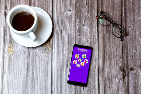 02/10/2021 Portsmouth, Hampshire, UK A mobile phone or cell phone laid on a wooden table with the test and protect Scotland app open on screenのeditorial素材
