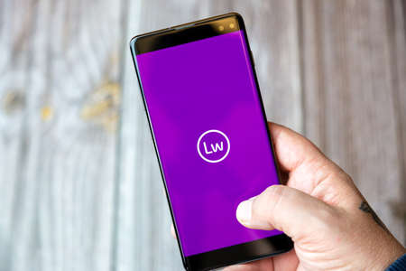 02-10-2021 Portsmouth, hampshire, UK A mobile phone or cell phone being held by a hand with the Littlewoods shopping app open on screenのeditorial素材