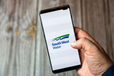 02-10-2021 Portsmouth, hampshire, UK A mobile phone or cell phone being held by a hand with the South west water app open on screenのeditorial素材