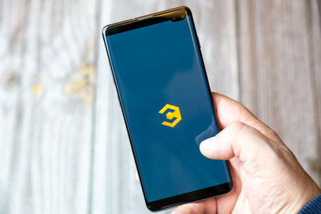 02-10-2021 Portsmouth, hampshire, UK A mobile phone or cell phone being held by a hand with the Coinbase Crypto app open on screenのeditorial素材
