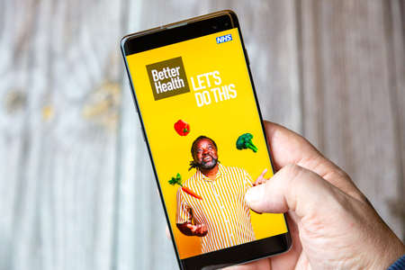 02-10-2021 Portsmouth, hampshire, UK A mobile phone or cell phone being held by a hand with the NHS Better health app open on screenのeditorial素材