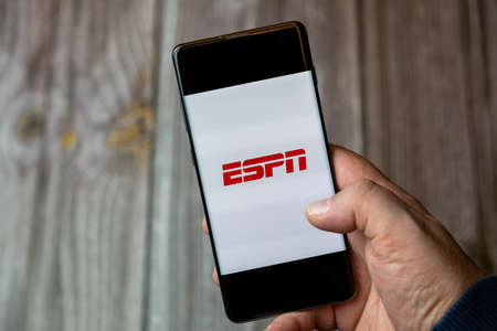 02-10-2021 Portsmouth, hampshire, UK A mobile phone or cell phone being held by a hand with the ESPN app open on screenのeditorial素材