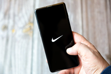02-10-2021 Portsmouth, hampshire, UK A mobile phone or cell phone being held by a hand with the Nike app open on screenのeditorial素材
