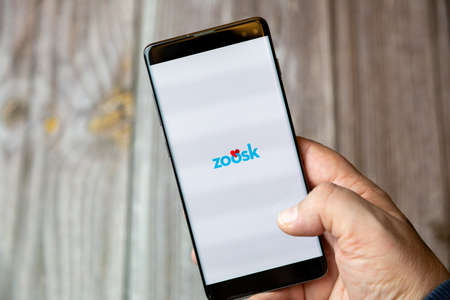 02-10-2021 Portsmouth, hampshire, UK A mobile phone or cell phone being held by a hand with the Zoosk app open on screenのeditorial素材