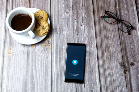 02-15-2021 Portsmouth, Hampshire, UK A mobile phone or cell phone laid on a wooden table with the Periscope app open on screenのeditorial素材