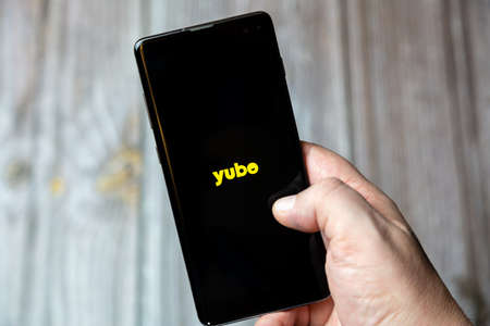 02-24-2021 Portsmouth, Hampshire, UK A mobile phone or cell phone being held by a hand with the Yubo app open on screenのeditorial素材