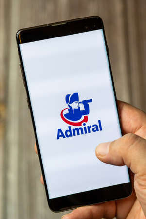 02-24-2021 Portsmouth, Hampshire, UK A mobile phone or cell phone being held by a hand with the admiral insurance app open on screenのeditorial素材