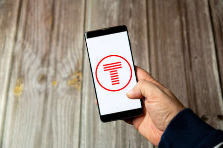 03-10-2021 Portsmouth, Hampshire, UK A Mobile phone or cell phone being held in a hand with the TFW...