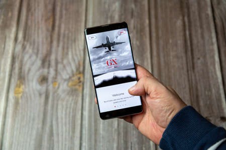 03-10-2021 Portsmouth, Hampshire, UK A Mobile phone or cell phone being held in a hand with the Gatwick Express app open on screenのeditorial素材