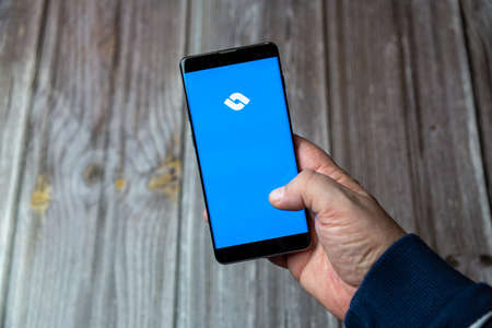 03-10-2021 Portsmouth, Hampshire, UK A Mobile phone or cell phone being held in a hand with the Ticket swap app open on screenのeditorial素材