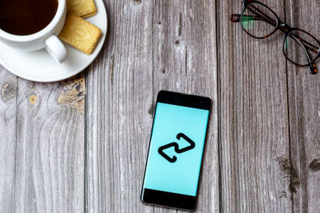 02-24-2021 Portsmouth, Hampshire, UK A mobile phone or cell phone on a wooden table with the Clear pay app open next to a coffee and glassesのeditorial素材