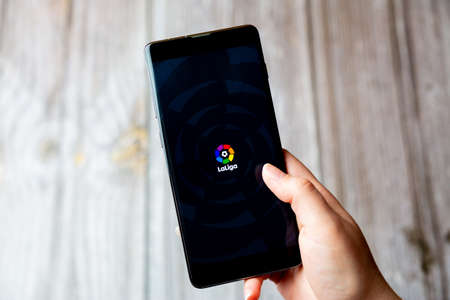 03-22-2021 Portsmouth, Hampshire, UK A mobile phone or cell phone being held in a hand with the La Liga app open on screenのeditorial素材