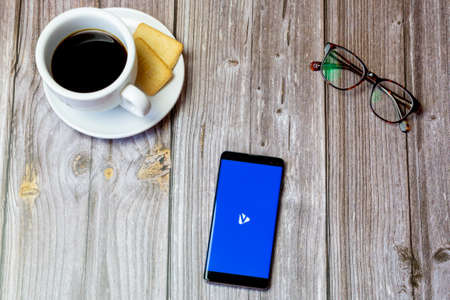 03-22-2021 Portsmouth, Hampshire, UK A mobile phone or cell phone laid on a wooden table with the...