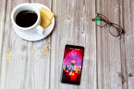 03-22-2021 Portsmouth, Hampshire, UK A mobile phone or cell phone laid on a wooden table with the Bayern Munich app open on screenのeditorial素材