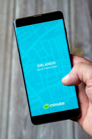 04-13-2021 Portsmouth, Hampshire, UK A Mobile phone or Cell phone being held in a hand showing the app on screenのeditorial素材