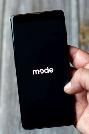 04-13-2021 Portsmouth, Hampshire, UK A Mobile phone or Cell phone being held in a hand showing the mode bitcoin app on screenのeditorial素材